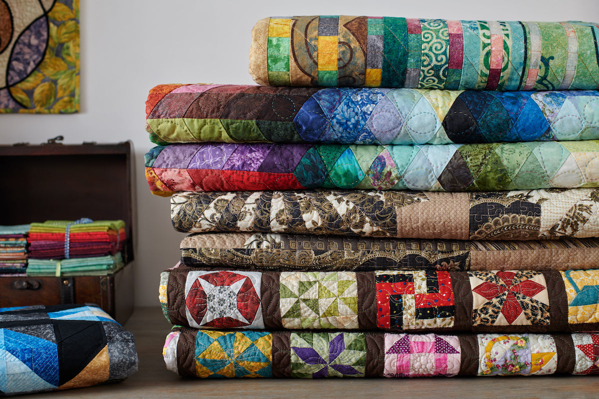 Stack of quilts and quilting fabrics