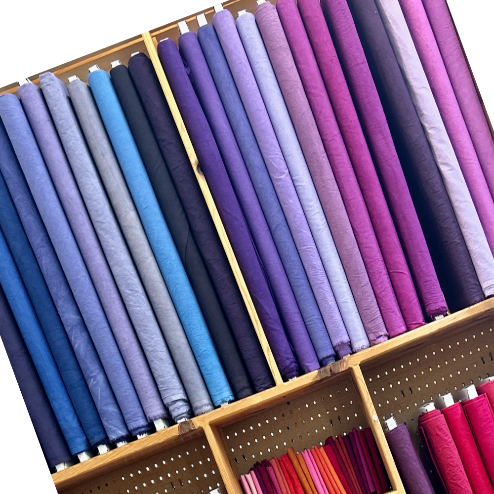 Cherrywood Hand-dyed fabric by the yard on bolts on a shelf