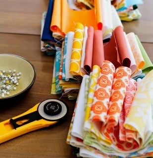 Quilted Strait sewing class supplies including rotary cutter and quilting fabric